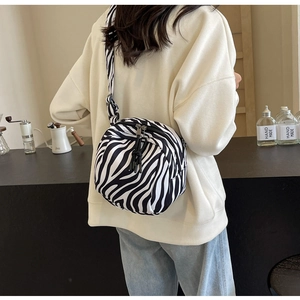 Détail d'un sac bandoulière motif zèbre avec double fermeture éclair et large sangle