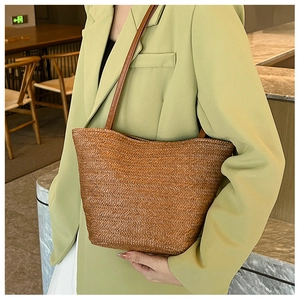 Close-up of brown woven tote bag with V-shaped texture shown on a female model