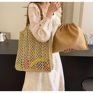 Close-up of woven straw tote bag with retro dark brown wooden bead handles and inner pouch