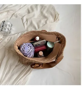 Top view of spacious straw tote bag interior showing capacity for umbrella and wallet