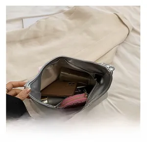 Internal view of the metallic silver bag showing spacious storage for daily essentials