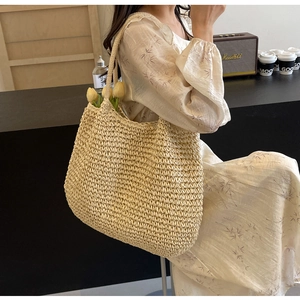 Close-up of beige woven tote bag textured fabric during casual outdoor photoshoot