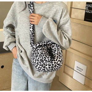 Détail du sac bandoulière en toile léopard avec doubles poches zippées et sangle large