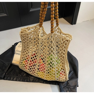 Hollow woven straw handbag with dark brown wooden bead handles and bohemian style