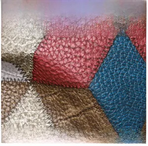 Macro detail of multi-color patchwork lychee grain leather with durable stitching