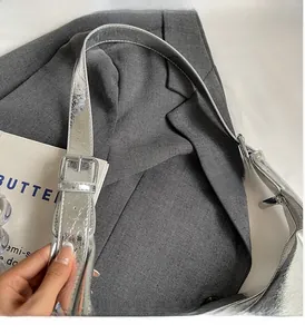 Close-up of silver metallic pleated leather strap and adjustable buckle on women's bag