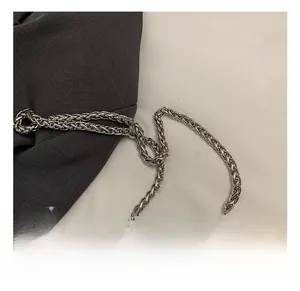 Detailed macro view of the silver woven metal chain strap with high-quality polished finish