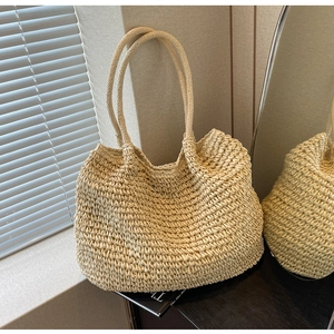 Minimalist woven straw tote bag with hand-knitted texture and dual handles for women