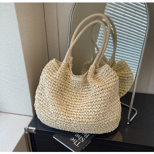 Minimalist beige woven straw tote bag with double handles for summer travel and vacation