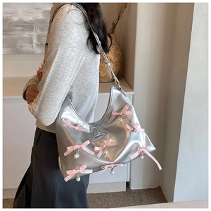 Silver Y2K hobo bag in PU leather featuring pink satin bows and hanging pearl charms