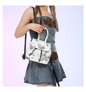 Detail of white PU leather backpack with butterfly print and drawstring closure
