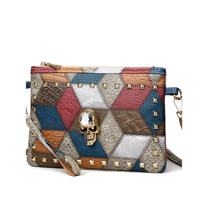 Retro multi-color patchwork leather crossbody bag with rivet studs and gold skull detail
