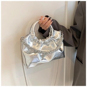 Detail view of silver cloud bag with metallic PU leather and hard circular handle