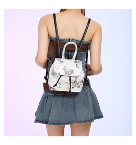 Detail of white mini PU leather backpack with butterfly print and drawstring closure