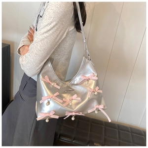Detail showing silver metallic PU leather bag with pink bows and pearl pendants for women