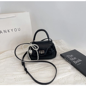 Mini black PU leather crossbody bag with pearl bow and silver heart charm decoration