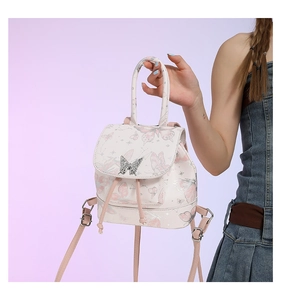 Close-up of cream PU leather backpack with butterfly print and silver metal buckle detail