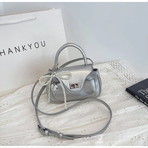 Metallic silver PU leather handbag with pearl bow charm and heart pendant detail