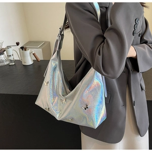 Detail of silver holographic PU leather bag with 3D metal butterfly decorations