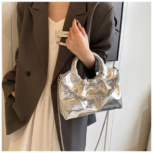 Detailed view of silver metallic PU leather bag with wrinkled texture and chain strap