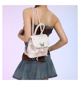 Detailed view of silver butterfly metal clasp and pink butterfly print on PU leather bag