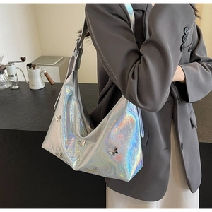 Detail of silver holographic crescent moon bag with metal butterflies on a model