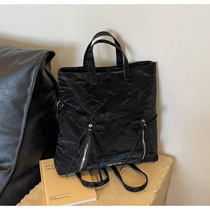Versatile black PU backpack with crinkled texture and symmetrical bow decoration