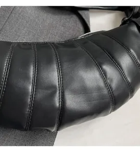 Close-up of black crescent quilted PU leather shoulder bag with silver metal zipper