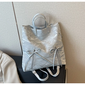 Light gray wrinkled PU leather backpack and handbag with decorative bows and silver zippers