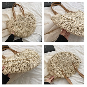 Detail view of round straw tote bag with brown leather straps and woven texture