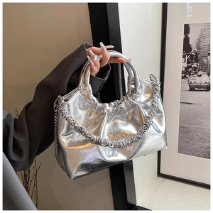 Detail of silver metallic cloud bag with gathered folds and elegant chain strap