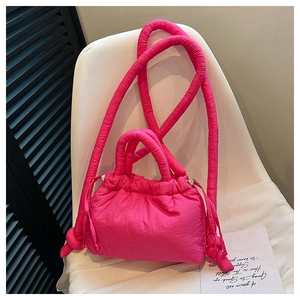 Quilted rose red crossbody bag with puffy shoulder strap and drawstring closure