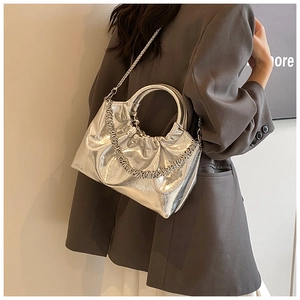 Detail view of silver mirror PU pleated crossbody bag with circular handle and chain strap