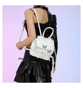 Close-up of white PU leather backpack with green butterfly prints and silver metal charm