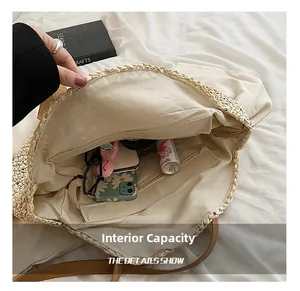 Detail view of large straw shoulder bag interior with beige lining and zip pocket