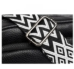 Detail showing high-quality metal buckle and black and white geometric woven shoulder strap