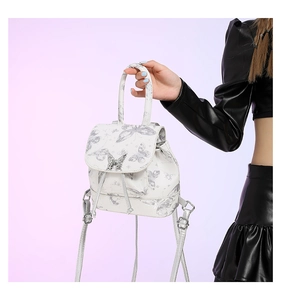 Detail of white PU mini backpack with silver butterfly print and metallic buckle