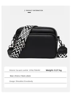 Detail of lychee pattern leather camera bag with wide geometric woven shoulder strap