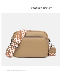 Detail of khaki lychee grain leather crossbody bag with geometric pattern wide strap