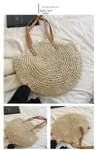 Detail of beige woven straw tote with brown leather handles and cross-stitch craft