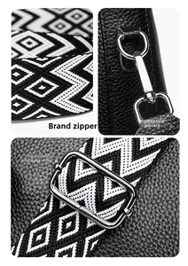 Detail of adjustable woven wide strap and silver metal hardware on leather bag