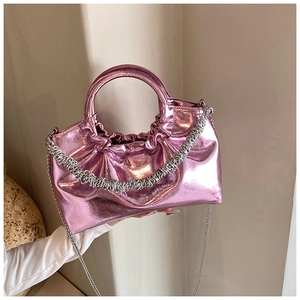 Detail of metallic pink PU leather crossbody bag with pleated texture and chain strap