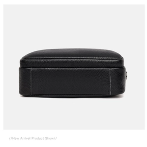 Detailed bottom view of black litchi grain leather bag showing fine stitching craftsmanship