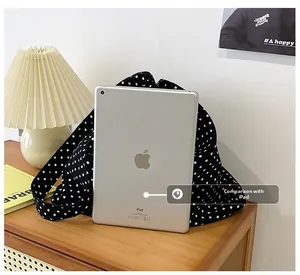 Detailed size comparison of the polka dot canvas tote bag shown next to an iPad