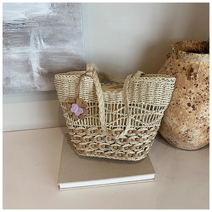 Chic beige and brown woven straw shoulder bag with an embroidered butterfly charm