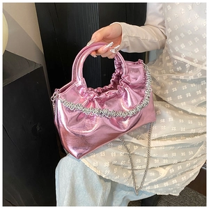 Close-up of pink metallic PU handbag with trendy pleated texture and silver chain strap