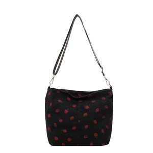 Chic black corduroy tote bag featuring vibrant red strawberry patterns and gold hardware