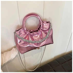 Detail of metallic pink PU crossbody bag with unique pleated texture and silver chain strap