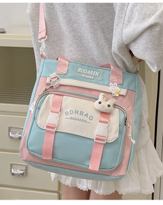 Close-up of pastel blue and pink nylon crossbody bag with cute rabbit pendant charm