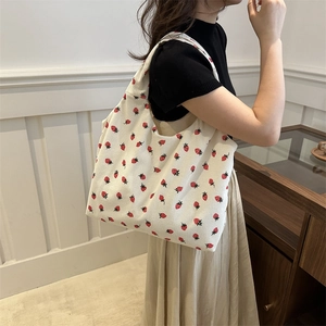 Minimalist beige corduroy tote bag with red strawberry print for daily casual use